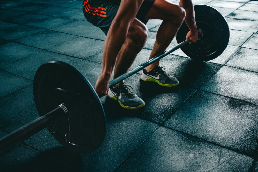 pexels-photo-841130-841130 Man performing a deadlift exercise in a gym, demonstrating strength and fitness.