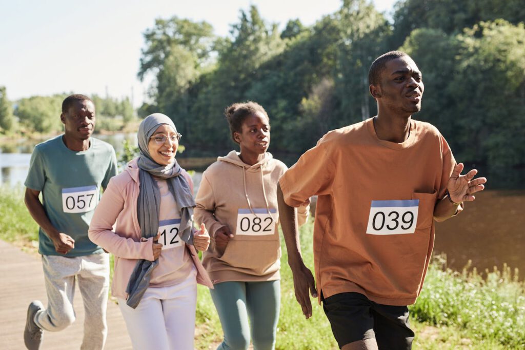 pexels-photo-8556686 A diverse group of adult runners competing in an outdoor marathon on a sunny day.